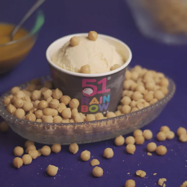 Creamy ice cream scoop with crunchy toppings served in a cup