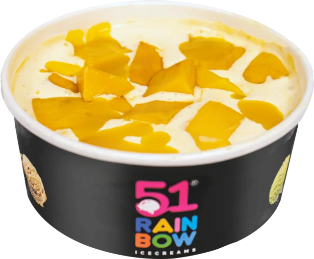 A bowl of Kesar mango ice cream topped with fresh golden mango chunks, served in a 51 Rainbow Ice Cream cup
