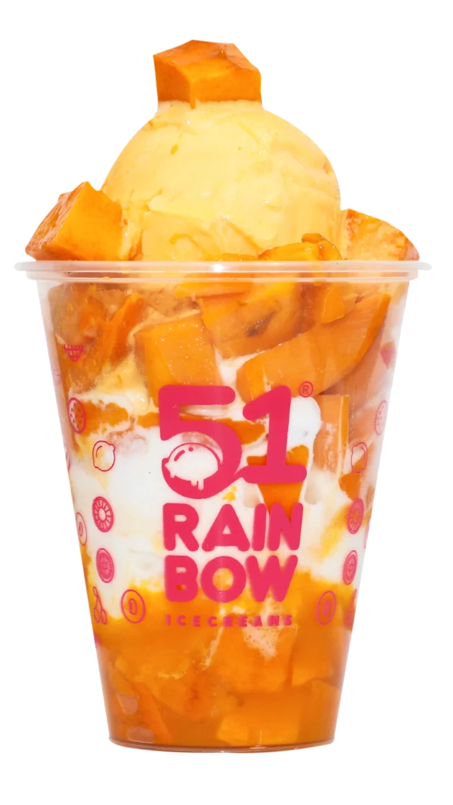 cup filled with layers of fresh mango chunks and creamy mango ice cream scoop