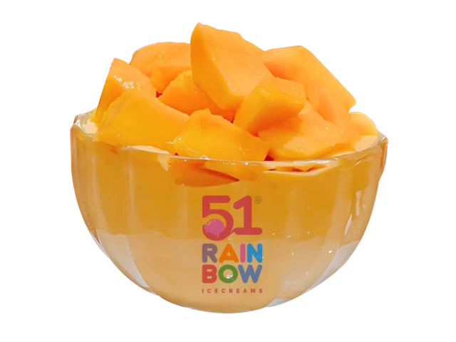 A glass bowl overflowing with freshly cut Alphonso mango chunks